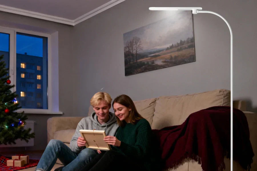 Adjustable floor lamp illuminating Christmas corner in rental apartment living room