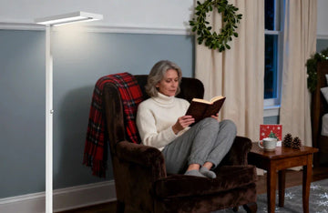 Family gathering in well-lit living room during Christmas with Honeywell 02E reading floor lamp and holiday decorations