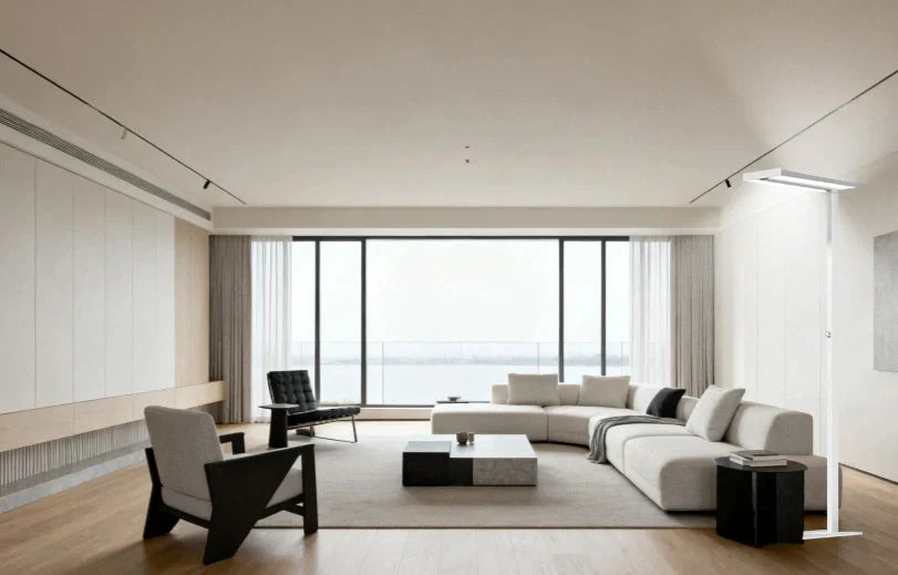 Modern floor lamp creating defined zones in open concept living space layout