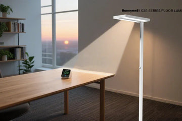 Home office workspace showing layered lighting with ceiling ambient fixture and desk task lamp