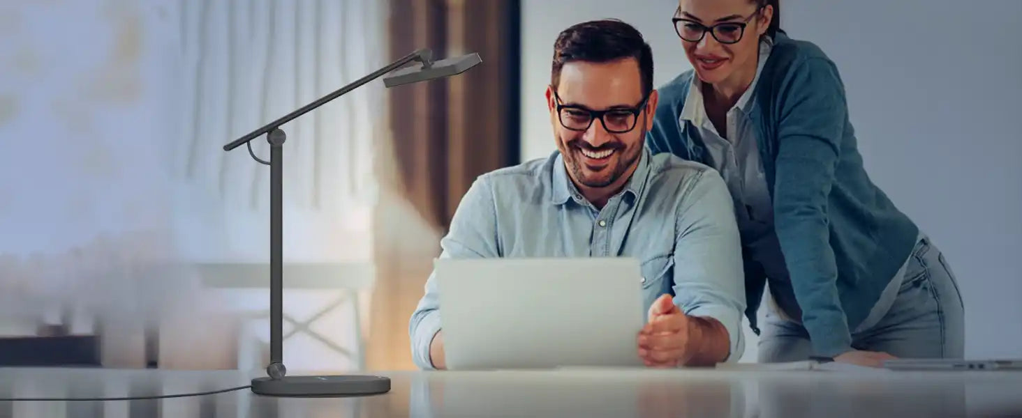 Two coworkers collaborating while looking at a laptop screen.slider_item_4c96gJ