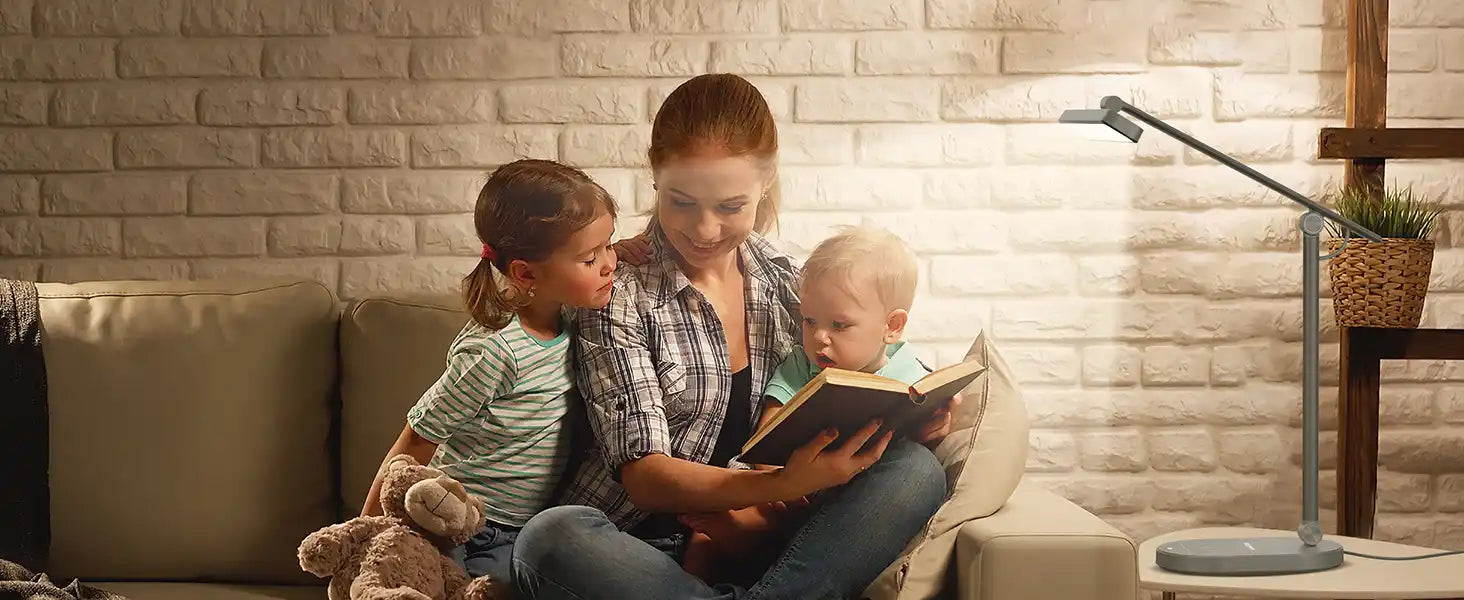 A family reading a book together on a couch.slider_item_RWjHx6