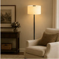 A sleek black Honeywell F3 Soft LED retro floor lamp with a cylindrical off-white fabric shade