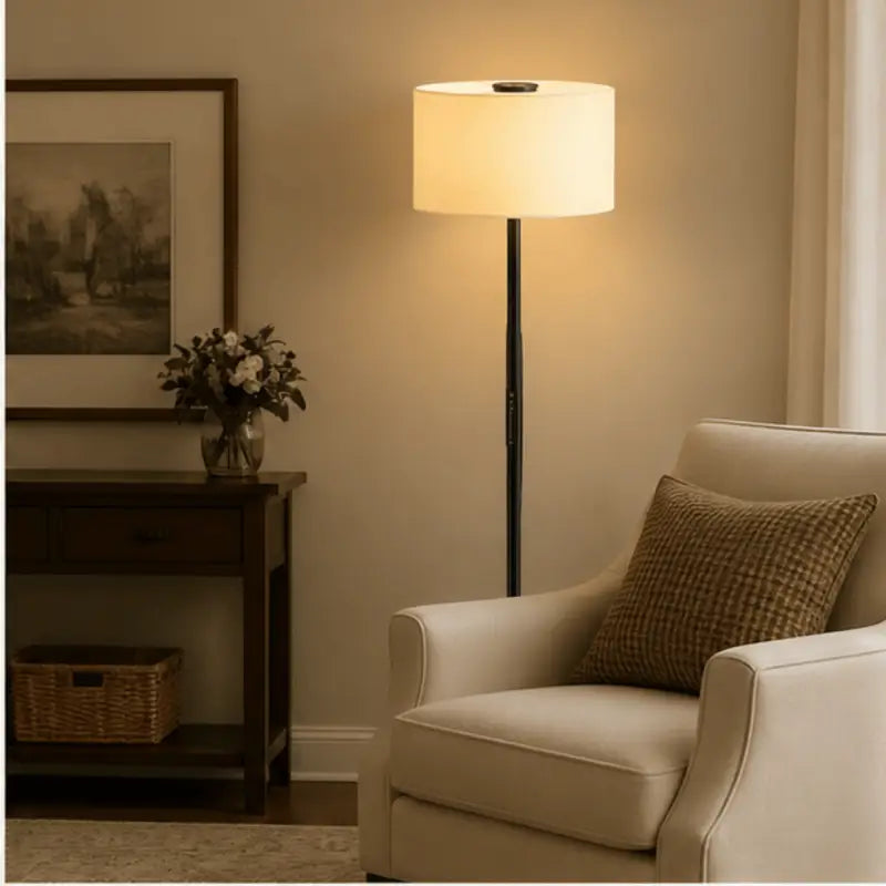 A sleek black Honeywell F3 Soft LED retro floor lamp with a cylindrical off-white fabric shade