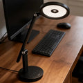 Black adjustable honeywell h6 desk lamp with circular led head and sleek modern design for home office use