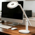 White minimalist honeywell h6 desk led lamp with circular adjustable head and sleek metallic joints for home office use