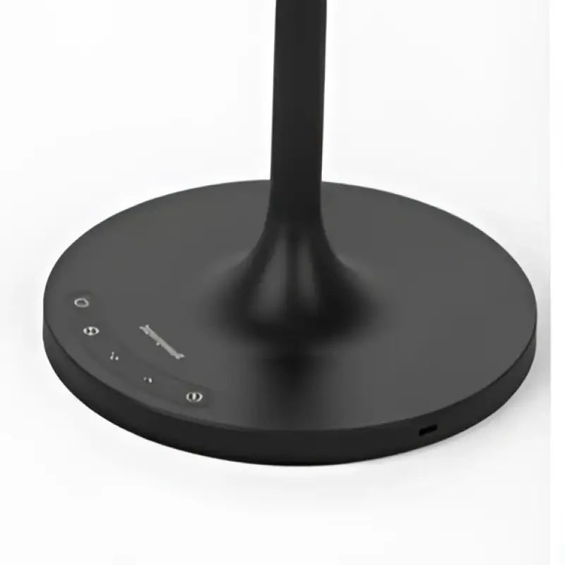 Black circular base of honeywell hwt-m2 table lamp with charging port and subtle control buttons in sleek minimalist design