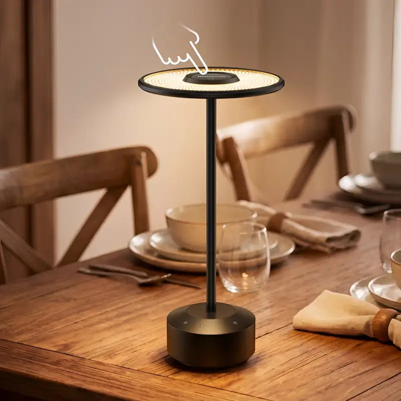 Black circular honeywell m4 portable rechargeable cordless led table lamp with sleek modern design and perforated top surface