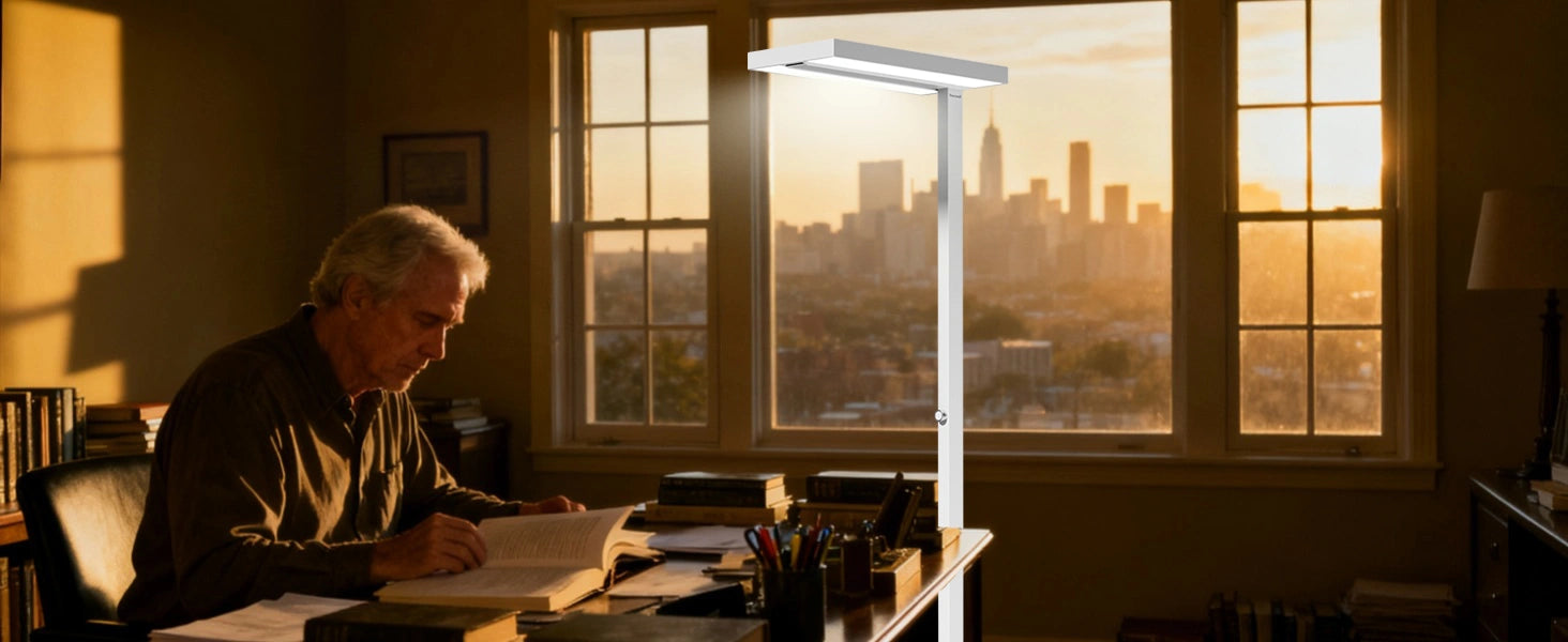 Elderly man reading comfortably under 6000 lux task lighting from adjustable floor lamp in winter evening